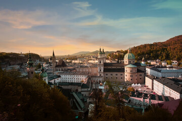 Fototapeta na wymiar The Skyline view of old historic Fortress Hohensalzburg in the Autumn trees fall background in Salzburg, Austria