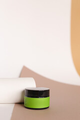Focus on jar of facial cream with green space for brand.