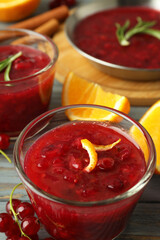 Cranberry sauce and ingredients on gray wooden table