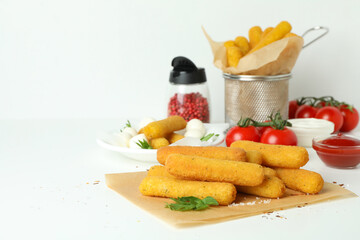Concept of tasty food with cheese sticks on white background