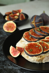 Plate with bruschetta with fig on two tone background