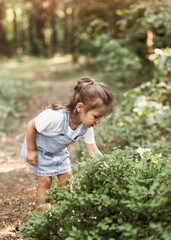 Positive charming little girl enjoying summer sunny day, expression emotions, having fun, happy child walking in summer day