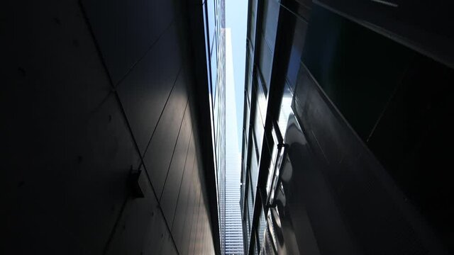 Walking through narrow path. Tiny sky above