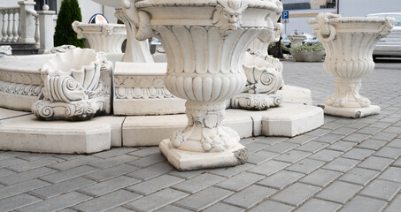 Decorative fountain and vases made of concrete on the city street