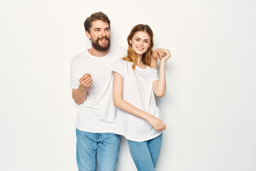 Fototapeta premium joyful man and woman in white t-shirts embrace friendship together