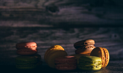 Gourmet dessert of French macarons on dark background.  Copy space. Selective focus.