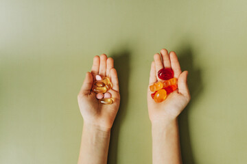 medicine pills and candies in children's hands