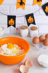 Step-by-step preparation of cottage cheese muffins for Halloween. Sweet cupcakes with monsters for kids. Mixing of ingredients: cottage cheese, eggs, sugar, flour. Vertical orientation.