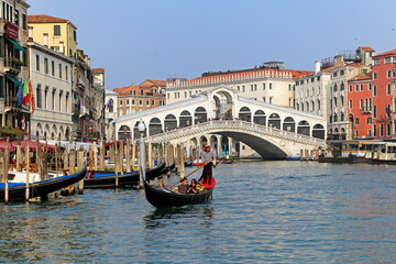 A couple of tourists during a romantic gondola trip on the grand canal, Venice.