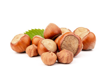 Ripe filbert and green leaves isolated on white