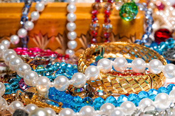 jewelry box, pearl beads and various other multicolored jewelry, soft focus, prosperity concept
