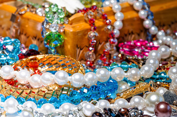 jewelry box, pearl beads and various other multicolored jewelry, soft focus, prosperity concept