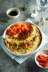 Traditional homemade omelette with tomatoes and salmon