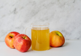 Apple vinegar and red apples on  white background