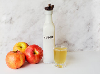 Apple vinegar and red apples on  white background