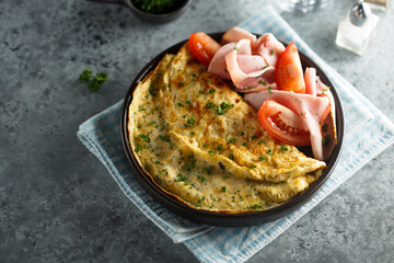 Traditional omelette with tomatoes and ham