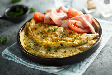 Traditional omelette with tomatoes and ham