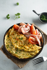 Traditional omelette with tomatoes and ham