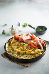 Traditional omelette with tomatoes and ham