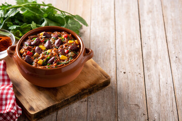 Traditional mexican tex mex chili con carne on wooden table.Copy space