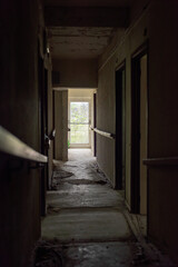 Fototapeta premium Dilapidated dirty hallway in an abandoned care home.