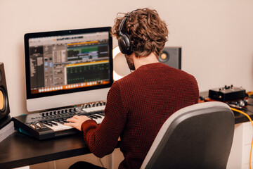 Male music producer working at home music studio