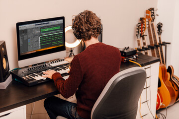 Male music producer working at home music studio