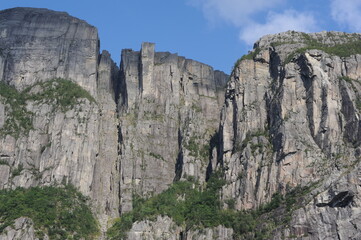 Preikestolen pulpit rock made of granite seen from below from the bottom of Lysefjord fjord and canyon in Norway