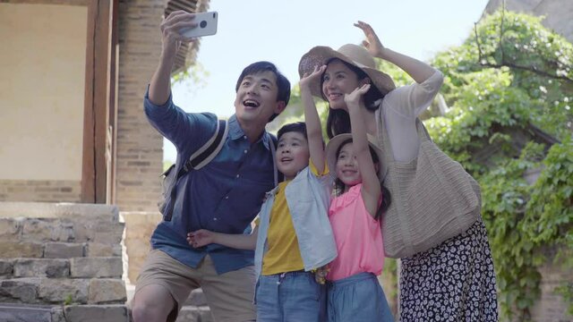 Happy young family taking selfie with smartphone,4K