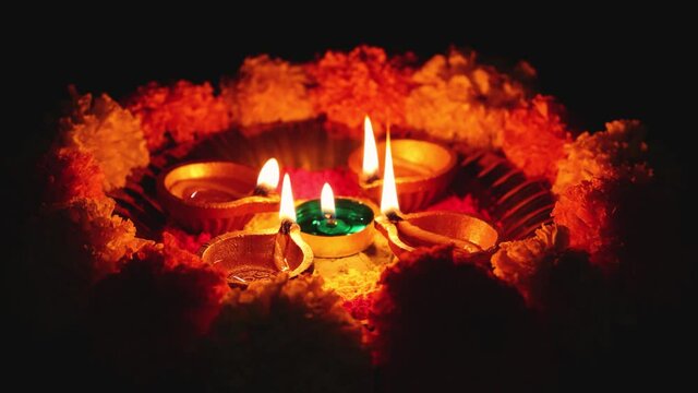 Diwali celebration Indian festival of lights Diya oil lamp and colors Rangoli decoration flowers flowerbed 4K footage video greetings Dipavali Hindu festival North India, Mumbai Delhi India