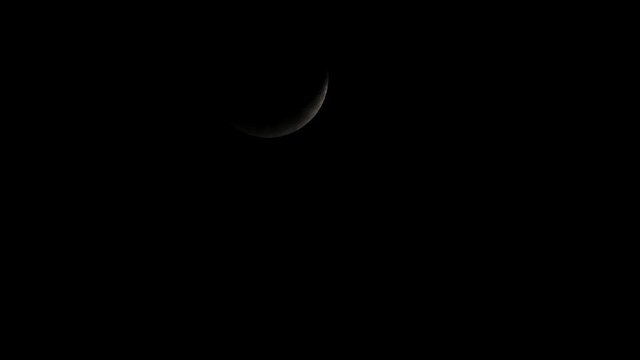 Waxing Crescent Moon covered with clouds then reveals again as it descends from the sky.