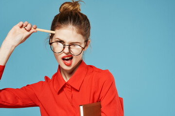woman in red shirt with notepad and pen secretary working office