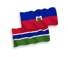National vector fabric wave flags of Republic of Haiti and Republic of Gambia isolated on white background. 1 to 2 proportion.