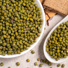 Raw mung bean on wooden table background.