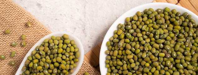 Raw mung bean on wooden table background.