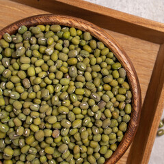 Raw mung bean on wooden table background.
