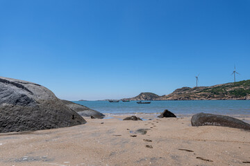 The sea under the blue sky, clean beaches and sea water, as well as islands and windmills