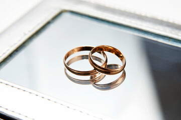 Two golden wedding rings background concept