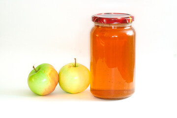 a jar of apple juice and apples