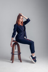 a red-haired girl is sitting on a chair