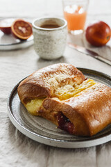 Breakfast with Twisted Bun with cheese and jam, hot chocolate, juice and oranges. Red-Jam and Cheese Danish. Selective focus