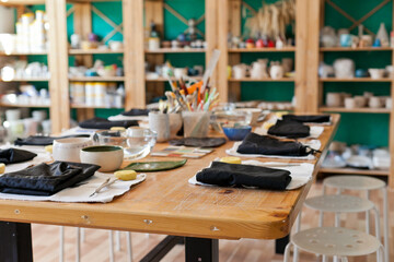 table with tools set for art master class at pottery studio