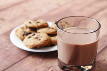 chocolate cooking and a glass of chocolate milkshake on table 