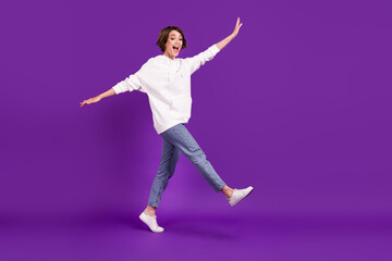 Fototapeta na wymiar Full size photo of young funky funny carefree smiling girl go walk fooling around isolated on purple color background