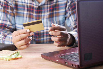 man hands holding credit card and using laptop shopping online 
