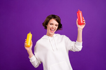 Photo portrait girl laughing keeping mustard ketchup bottles isolated vibrant pastel color...