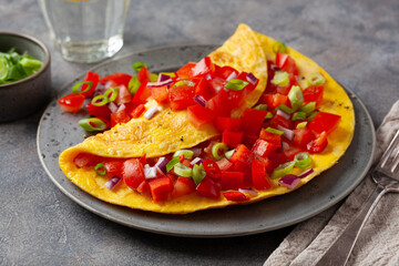 omelette with tomato, bell pepper onion chili and cheese. healthy breakfast