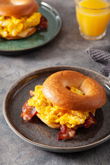 breakfast egg and bacon sandwich on bagel with cheese