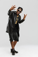 Young black man in sunglasses smiling and gesturing at camera