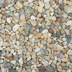 Natural colorful pebble stones background texture with copy space.